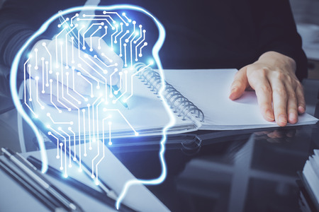 Double exposure of writing hand on background with brain hologram. Concept of learning.
