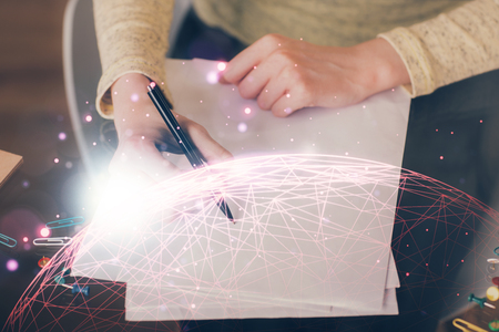 Social network theme hologram over hands taking notes background. Concept of global international people connect. Double exposureの写真素材