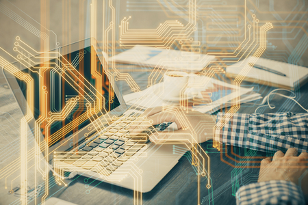 Technology theme hologram with man working on computer on background. High tech concept. Double exposure.の写真素材