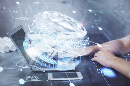 Businessman with computer background with technology theme hologram. Concept of hightech. Multi exposure.の写真素材