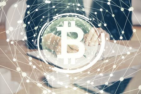 Cryptocurrency hologram over hands taking notes background. Concept of blockchain. Multi exposureの写真素材