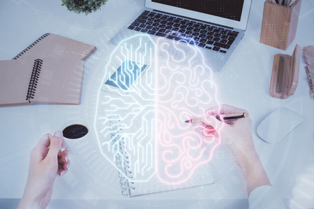 Double exposure of womans writing hand on background with brain hud. Concept of learning.の写真素材
