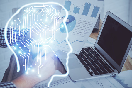 Businessman with computer background with brain theme hologram. Concept of brainstorm. Multi...