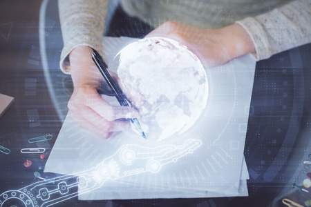 Multi exposure of hands making notes with world map hologram and data theme icons. Concept of global computer data.の写真素材
