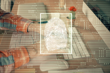 Fingerprint hologram with businessman working on computerの写真素材