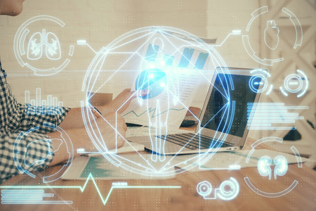 Science hologram with man working on computerの写真素材