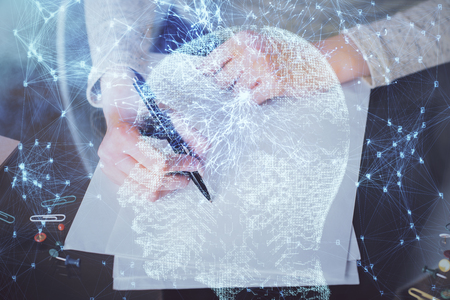 Double exposure of writing hand on  with brain hologram. Concept of learning.の写真素材