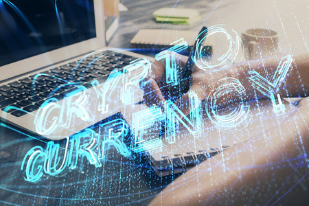 Cryptocurrency hologram over hands taking notesの写真素材