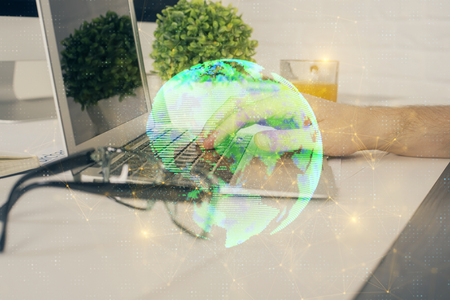 Social network theme hologram with businessman working on computerの写真素材