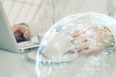 Social network theme hologram with businessman working on computerの写真素材