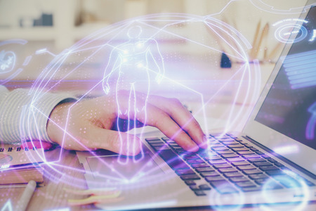 Science hologram with man working on computer on background. Concept of study. Double exposure.の写真素材