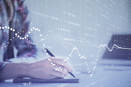 Double exposure of womans writing hand on background with data technology hud. Big data concept.の写真素材
