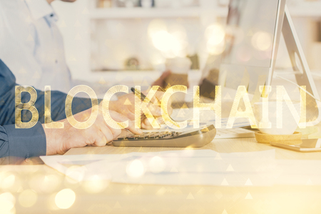 Crypto currency theme hologram with businessman working on computer on background. Concept of blockchain. Double exposure.の写真素材