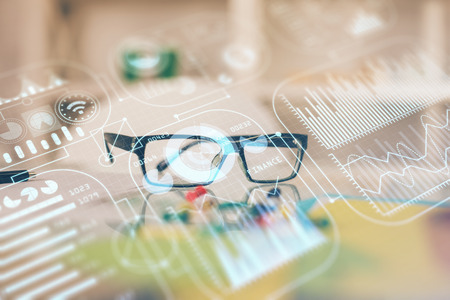 Tech theme hologram with glasses on the table background. Technology concept. Double exposure.の写真素材