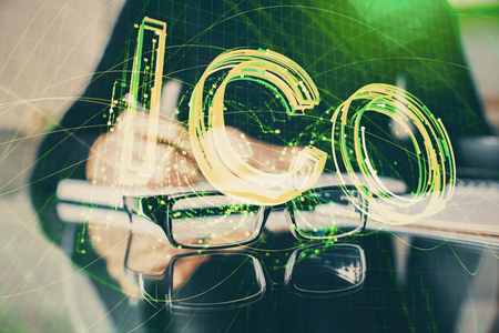 Cryptocurrency hologram over womans hands writing background. Concept of blockchain. Multi exposureの写真素材