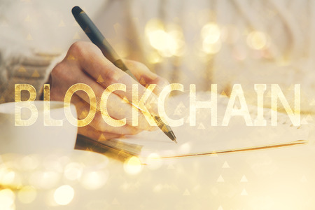 Cryptocurrency hologram over hands taking notes background. Concept of blockchain. Multi exposureの写真素材