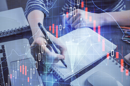 Financial chart drawn over hands taking notes background. Concept of research. Double exposure