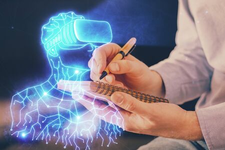 Abstract man wearing augmented reality headsets computer work with writing human background. AR concept. Double exposure.の写真素材