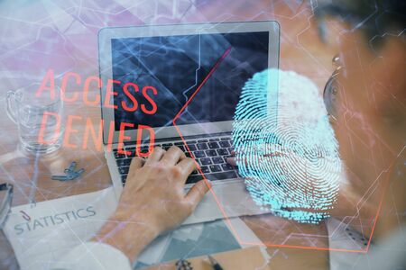Fingerprint hologram with businessman working on computer on background. Security concept. Double exposure.の写真素材