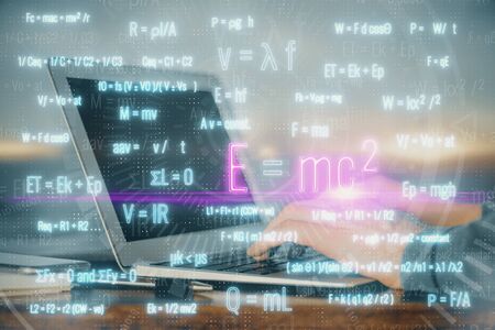 Science formula hologram with man working on computer on background. Education concept. Double...