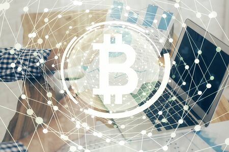 Crypto currency theme hologram with businessman working on computer on background. Concept of...