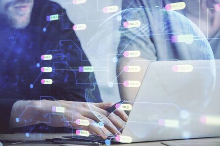 Multi exposure of data internet theme hologram with man working on computer on background. Concept...