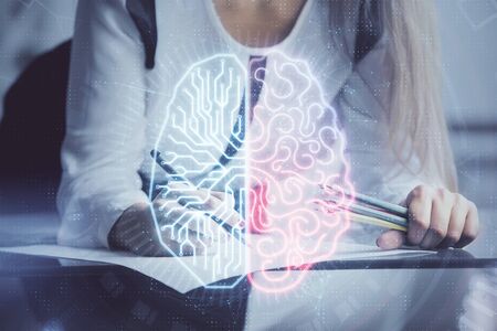 Multi exposure of womans writing hand on background with brain hud. Concept of learning.の写真素材