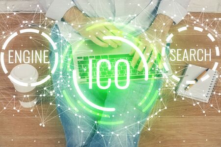 Crypto currency theme hologram with businessman working on computer on background. Concept of blockchain. Double exposure.の写真素材