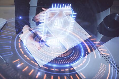 Double exposure of writing hands on background with data solution hologram on front. Technology concept. TOP view.の写真素材