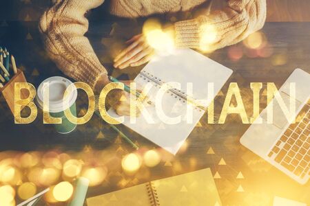 Cryptocurrency hologram over hands taking notes background. Concept of blockchain. Multi exposure