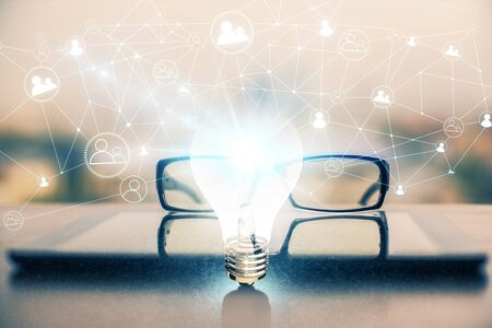Bulb drawing with glasses on the table background. Idea concept. Double exposure.