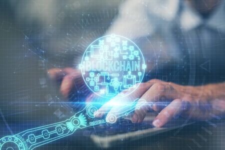 Crypto currency theme hologram with businessman working on computer on background. Concept of blockchain. Double exposure.の写真素材