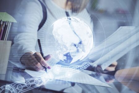 Multi exposure of hands making notes with world map hologram and data theme icons. Concept of global data.の写真素材