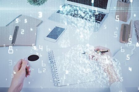Double exposure of writing hand on background with data technology hologram. Big data concept.の写真素材