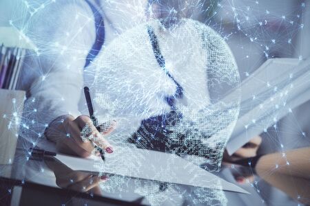 Multi exposure of woman's writing hand on background with brain hud. Concept of learning.の写真素材