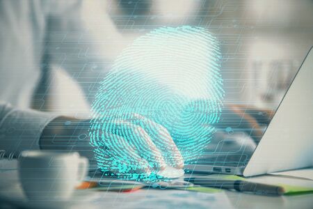 Fingerprint hologram with businessman working on computer on background. Security concept. Double...