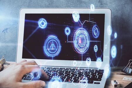 Double exposure of data internet theme hologram with man working on computer on background. Concept...