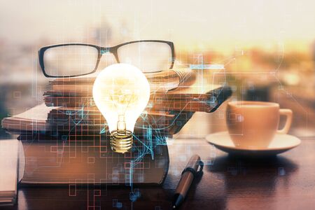 Bulb drawing with glasses on the table background. Idea concept. Double exposure.の写真素材