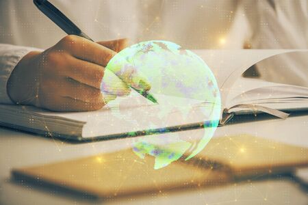 Social network theme hologram over hands taking notes background. Concept of global international people connect. Double exposureの写真素材