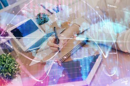 International business hud over womans hands writing background. Concept of hard work. Double exposureの写真素材