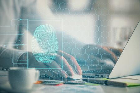 Fingerprint hologram with businessman working on computer on background. Security concept. Double...