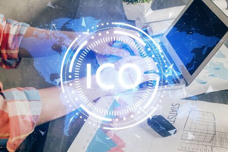 Crypto currency theme hologram with businessman working on computer on background. Concept of blockchain. Double exposure.の写真素材