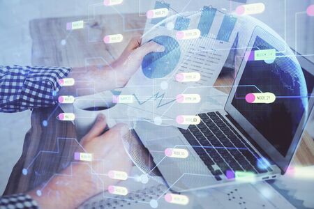 Multi exposure of technology hologram with man working on computer background. Concept of big data.の写真素材