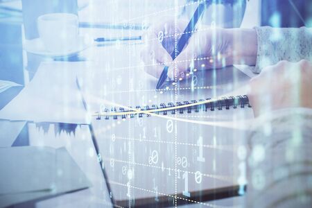 Double exposure of writing hand on background with data solution technology hologram. Ai concept.の写真素材