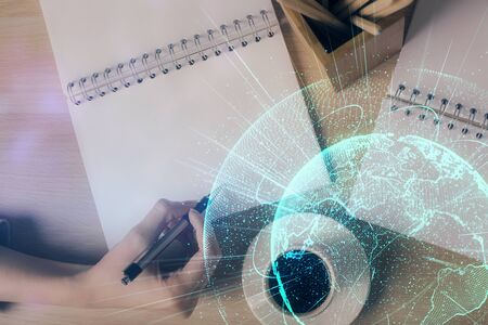 Social network theme hologram over hands taking notes background. Concept of global international people connect. Double exposureの写真素材