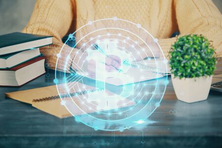 Cryptocurrency hologram over hands taking notes background. Concept of blockchain. Multi exposureの写真素材