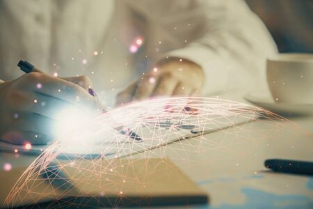 Social network theme hologram over hands taking notes background. Concept of global international...