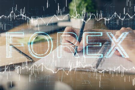 Financial forex graph drawn over hands taking notes background. Concept of research. Multi exposureの写真素材