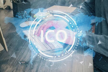 Crypto currency theme hologram with businessman working on computer on background. Concept of...