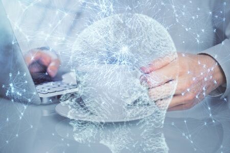 Man with computer background with brain theme hologram. Concept of brainstorm. Double exposure.